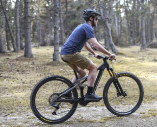 A man rides a mountain bike through the forest