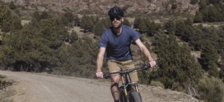 A man rides a mountain bike along a cycle path