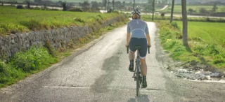 A woman rides a bicycle with Terry Arteria saddle