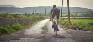 Road cyclist rides down the road