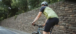 Cyclist rides along a wall