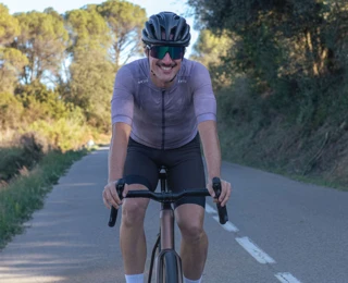 A man rides a racing bike on a road